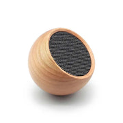 głośnik bezprzewodowy drewniany o kulistym kształcie z czarną siateczką głośnikową