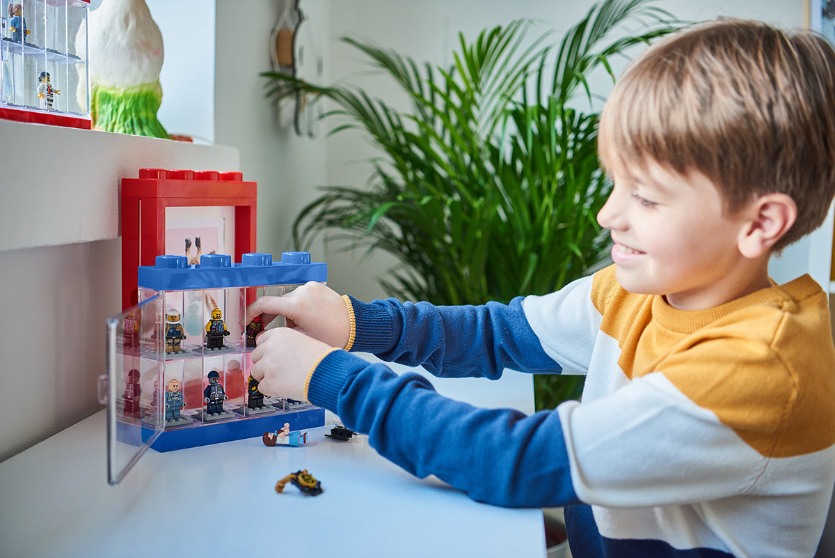 Gablotka na minifigurki LEGO z przezroczystym frontem używana przez chłopca do układania figurek