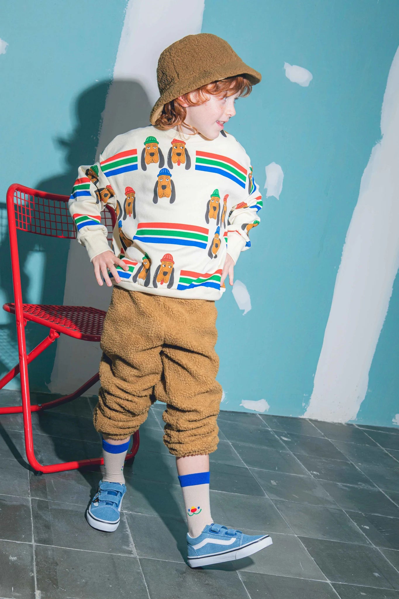 Dziecko noszące skarpetki dla dzieci Jolly Bear, niebieskie buty i ubrania z wzorem misia