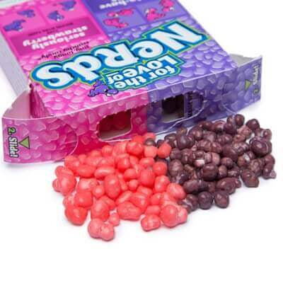 Bombons Nerds uva morango em embalagem Yamann roxa e rosa com bolinhas coloridas espalhadas