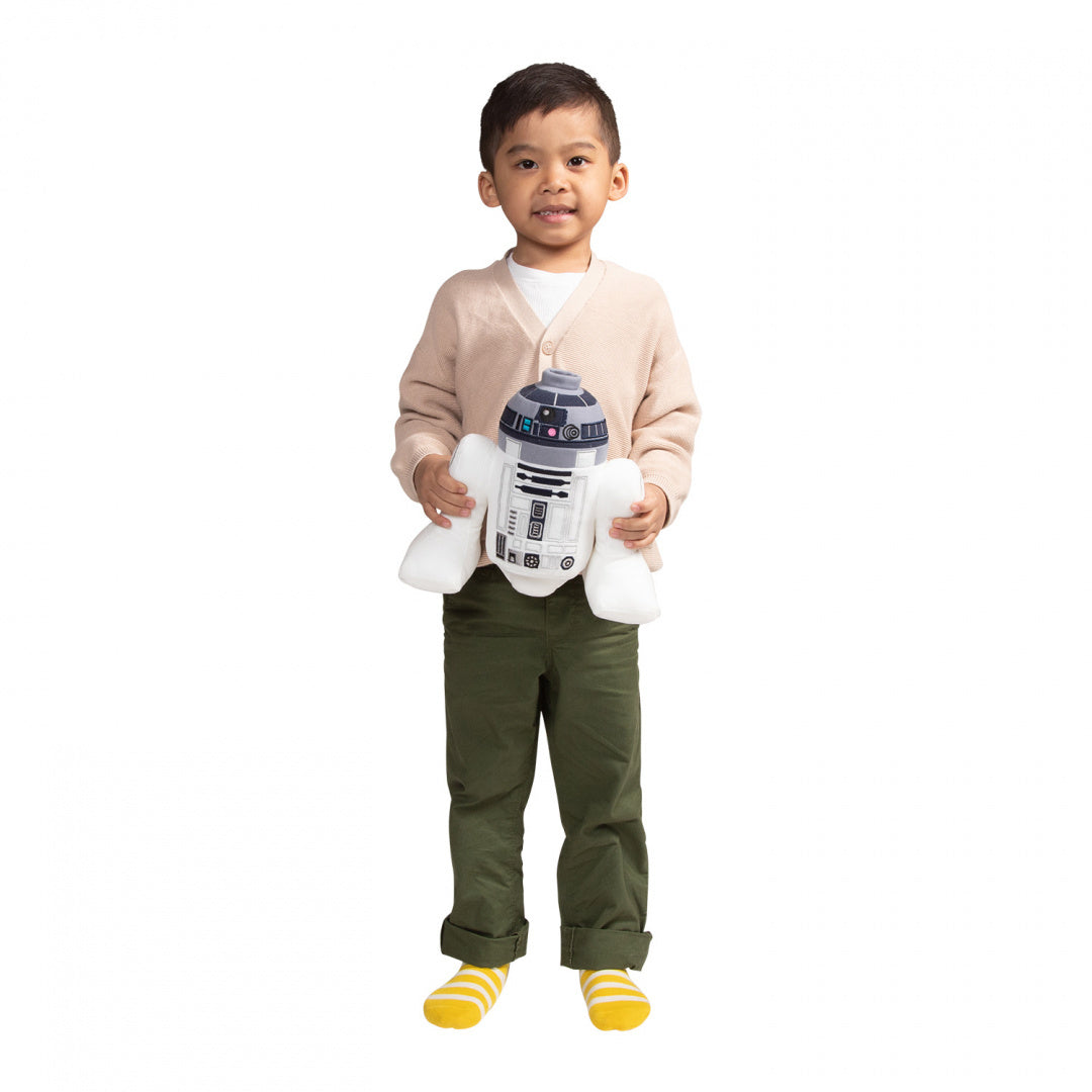 Chłopiec trzymający pluszak R2-D2 Star Wars od LEGO® w białym tle