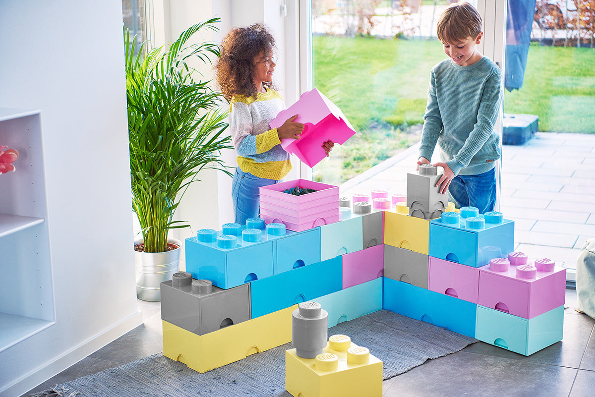 Dzieci bawiące się kolorowymi pojemnikami LEGO Brick z szarym pojemnikiem LEGO Brick 4 szary