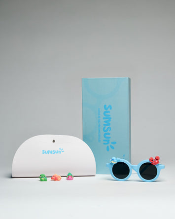 SumSun children's sunglasses in blue frames with a case and colorful decorations.