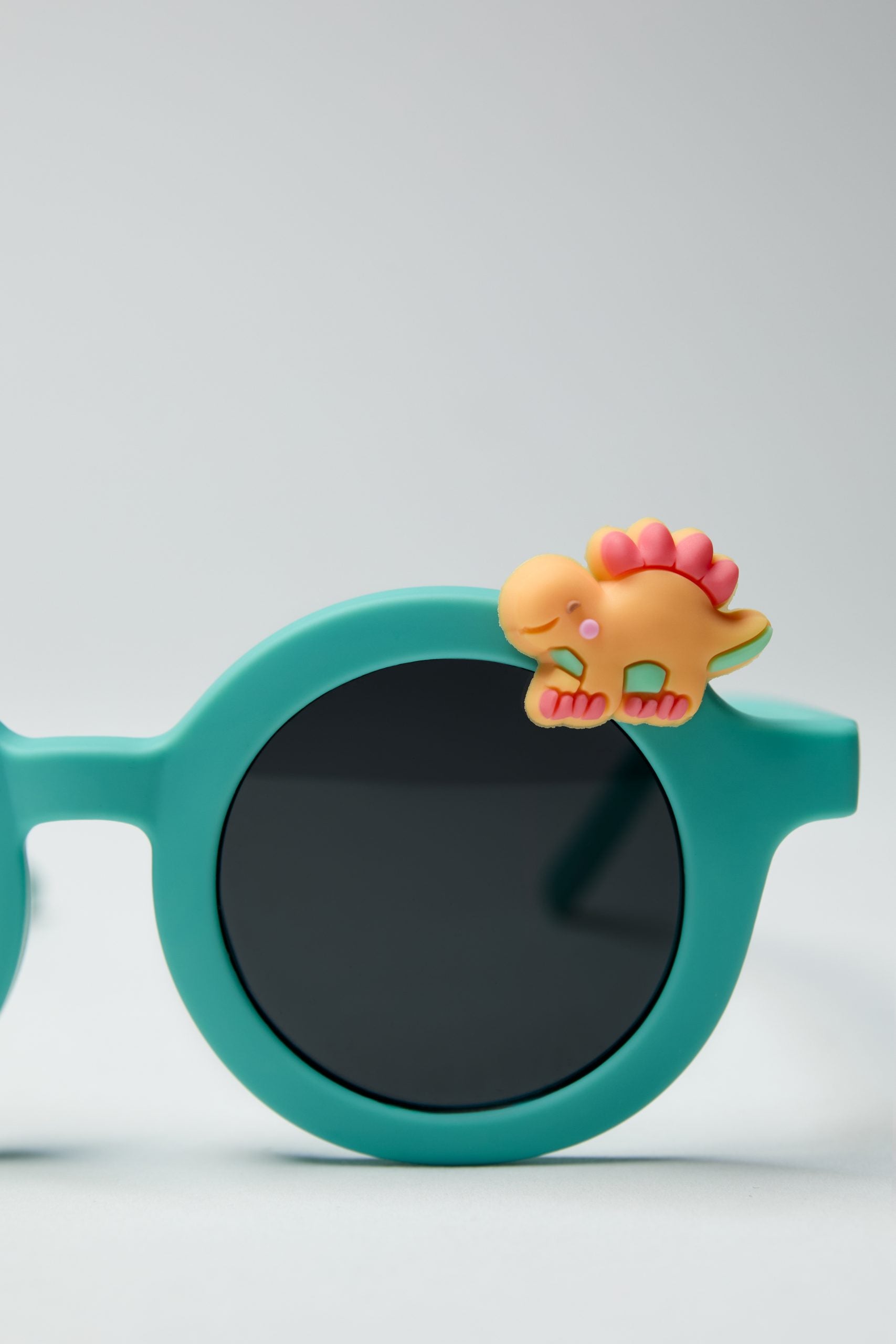 Turkusowe okulary przeciwsłoneczne dla dzieci z ozdobą dinozaura na oprawce